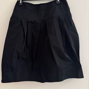 Lida Biday size 4 mini skirt with pockets. Nylon feel with zipper in back.